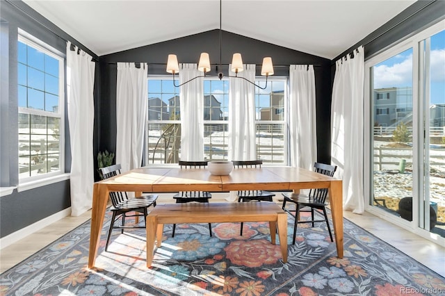 dining room featuring wood-type flooring, a chandelier, and vaulted ceiling