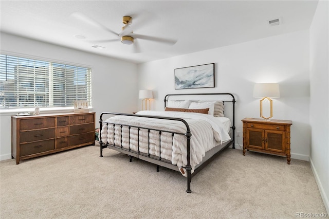 bedroom featuring light carpet and ceiling fan