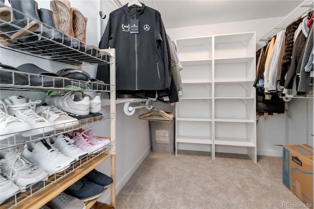 walk in closet with light colored carpet