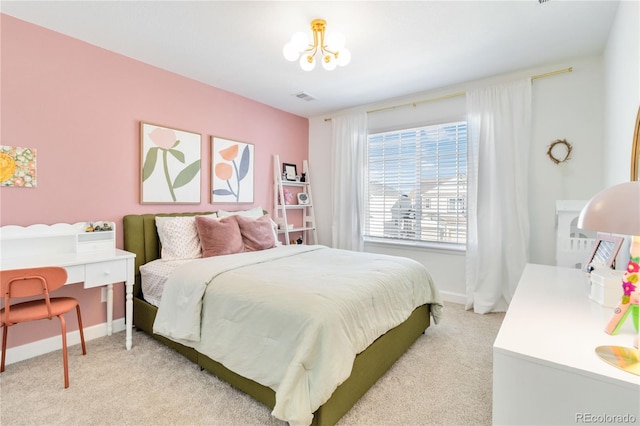 carpeted bedroom featuring a chandelier