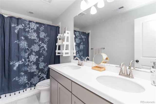 bathroom featuring tile patterned floors, toilet, and vanity