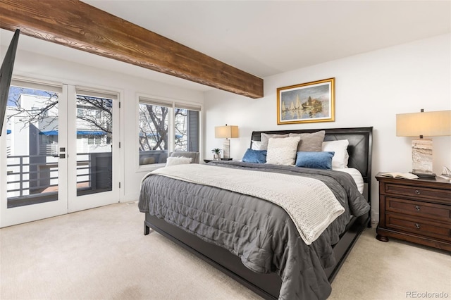 carpeted bedroom with beam ceiling and access to outside