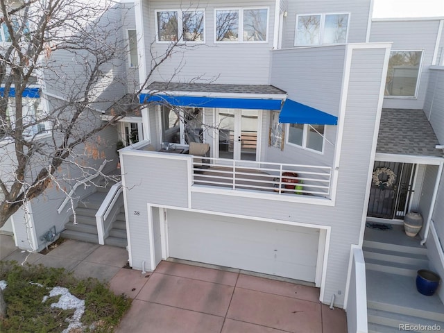 view of front of property with a garage and a balcony