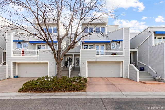 view of property with a garage and a balcony