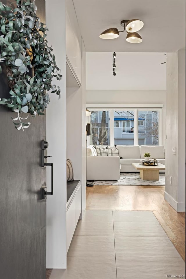 hallway with light hardwood / wood-style floors