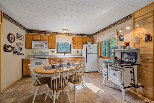 3938 County Road 60, Grant, CO 80448 - kitchen with white appliances, plenty of natural light, light countertops, and brown cabinets