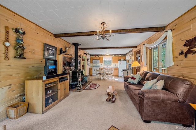 3938 County Road 60, Grant, CO 80448 - living room with a wood stove, wood walls, light colored carpet, beam ceiling, and a chandelier