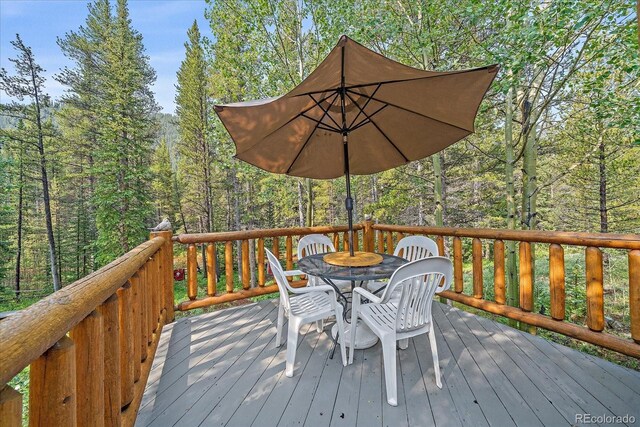 3938 County Road 60, Grant, CO 80448 - wooden terrace featuring outdoor dining area and a forest view