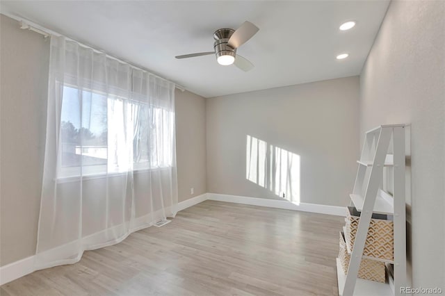 empty room featuring light wood-type flooring and ceiling fan