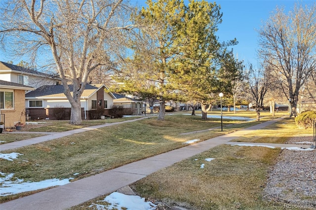 view of property's community with a yard