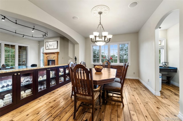 dining room featuring an inviting chandelier and light wood-type flooring