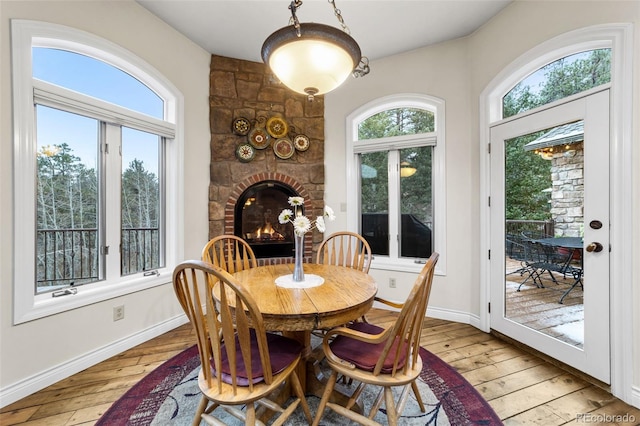 dining space featuring a fireplace and light hardwood / wood-style floors