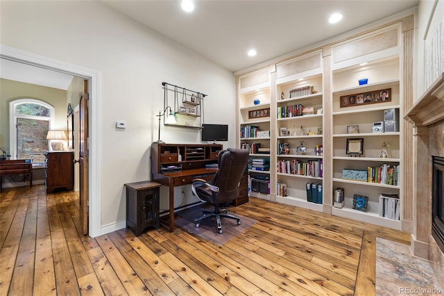 home office with wood-type flooring