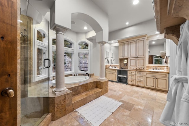 bathroom featuring vanity, separate shower and tub, and decorative columns