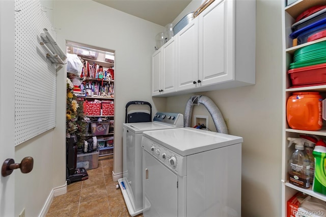 laundry area with cabinets, washer and dryer, and light tile patterned floors