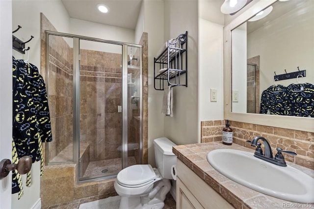 bathroom featuring vanity, tile patterned floors, toilet, and walk in shower