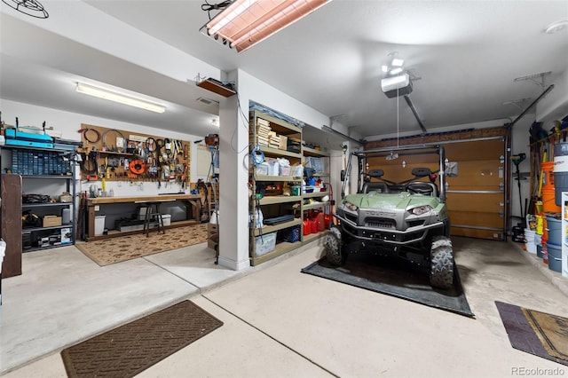 garage featuring a garage door opener and a workshop area