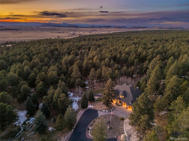 aerial view at dusk featuring a mountain view