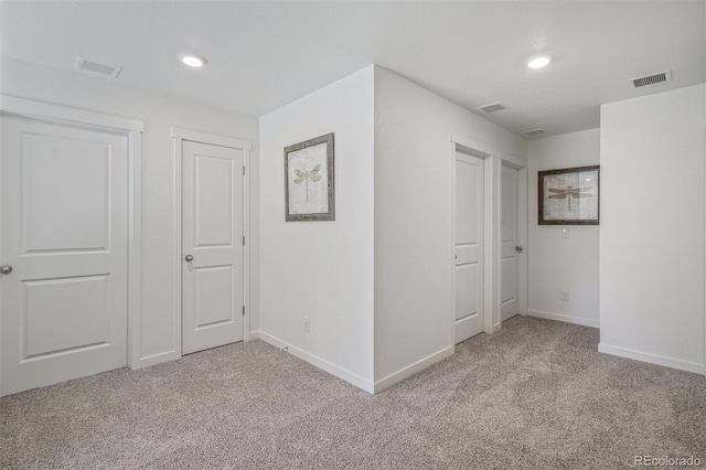 hallway with light colored carpet