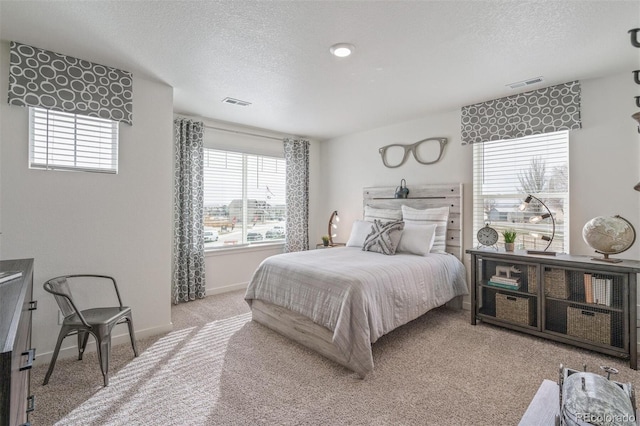 carpeted bedroom with a textured ceiling