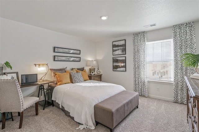 bedroom featuring light carpet