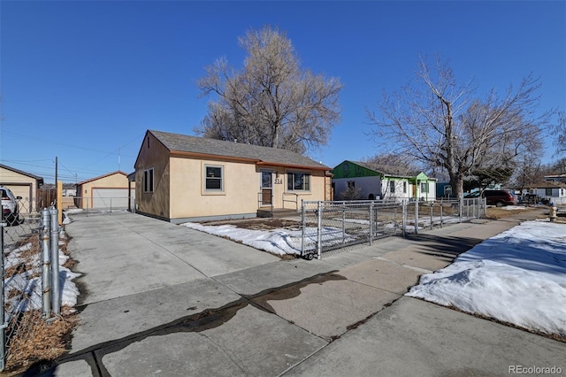 view of front of home with a garage and an outbuilding