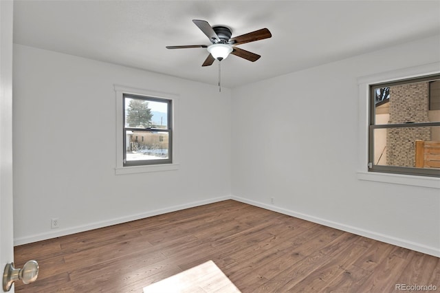 unfurnished room with hardwood / wood-style flooring and ceiling fan