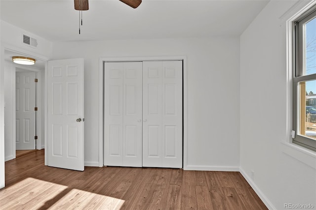 unfurnished bedroom with a closet, ceiling fan, and light hardwood / wood-style flooring