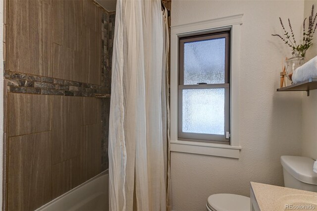 full bathroom with vanity, shower / tub combo with curtain, and toilet