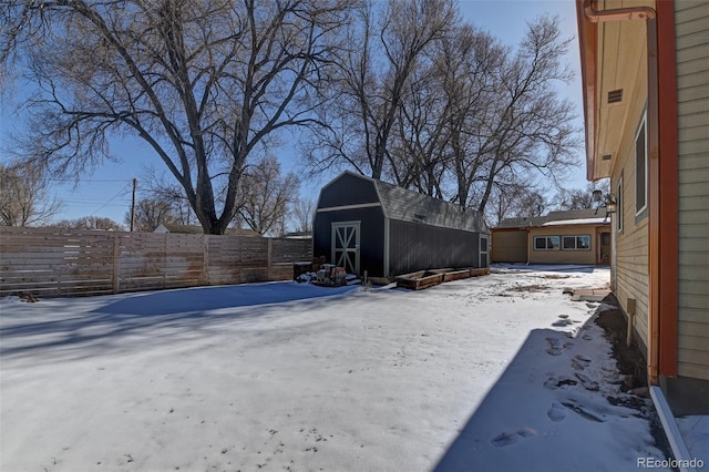 yard covered in snow with a storage unit