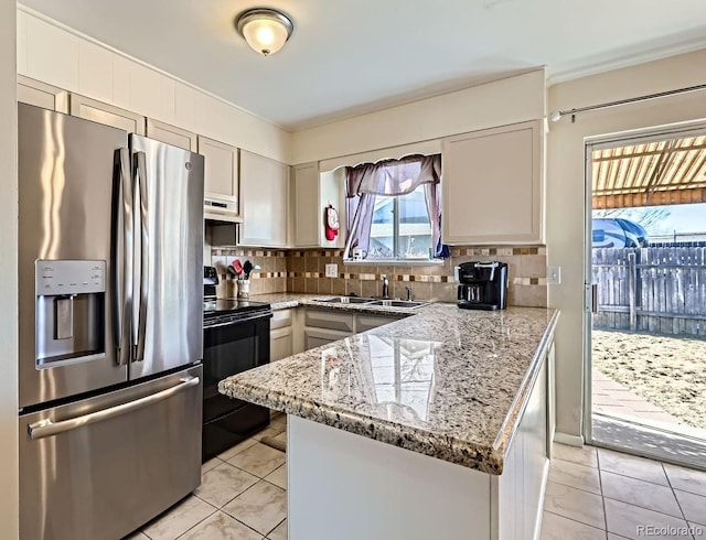 kitchen featuring stainless steel fridge with ice dispenser, light tile patterned floors, black / electric stove, light stone countertops, and backsplash