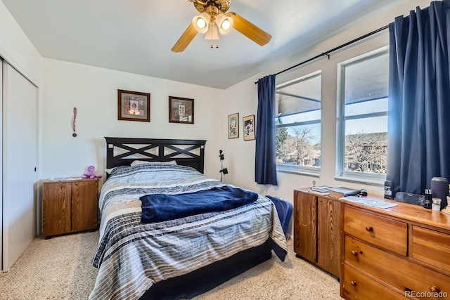 bedroom featuring ceiling fan and a closet