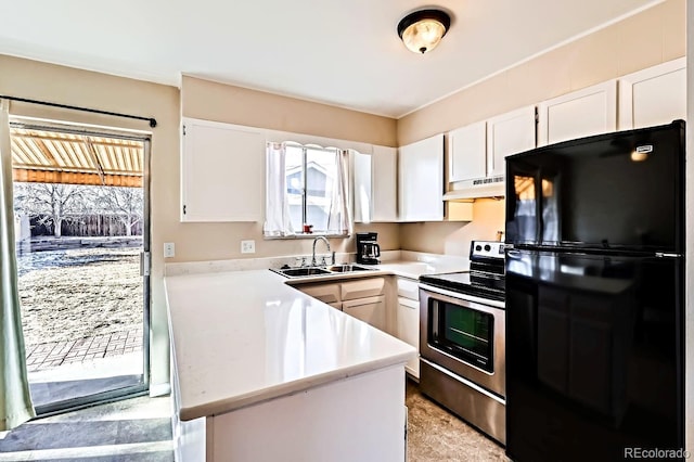 kitchen featuring black refrigerator, white cabinetry, sink, and stainless steel electric range