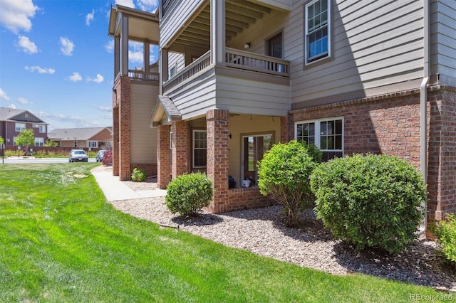 12914 Ironstone Way Unit 102, Parker, CO 80134 - view of home's exterior with brick siding and a yard