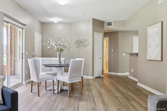 12914 Ironstone Way Unit 102, Parker, CO 80134 - dining room with light wood-style floors, plenty of natural light, and baseboards