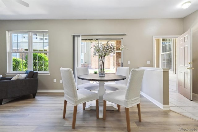 12914 Ironstone Way Unit 102, Parker, CO 80134 - dining area featuring plenty of natural light, light wood-style flooring, and baseboards