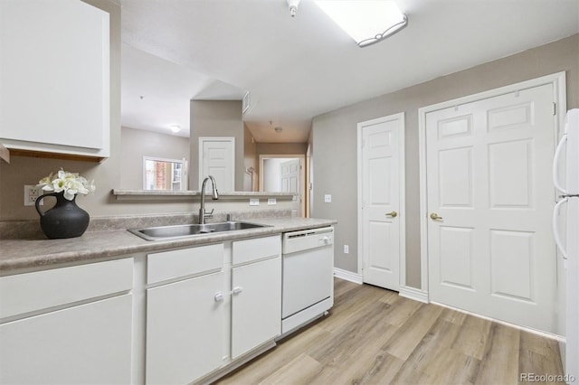 12914 Ironstone Way Unit 102, Parker, CO 80134 - kitchen featuring white appliances, a sink, white cabinets, light wood-style flooring, and light countertops