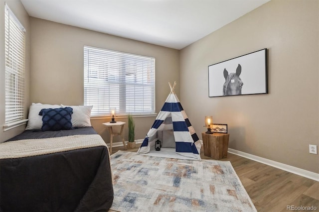 12914 Ironstone Way Unit 102, Parker, CO 80134 - bedroom featuring wood finished floors and baseboards