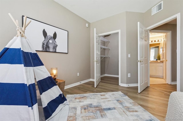 12914 Ironstone Way Unit 102, Parker, CO 80134 - bedroom featuring wood finished floors, baseboards, a walk in closet, and french doors