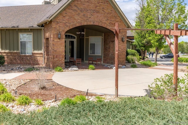12914 Ironstone Way Unit 102, Parker, CO 80134 - property entrance with brick siding, board and batten siding, and a shingled roof