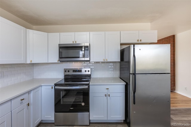 kitchen featuring white cabinetry, light countertops, tasteful backsplash, and appliances with stainless steel finishes