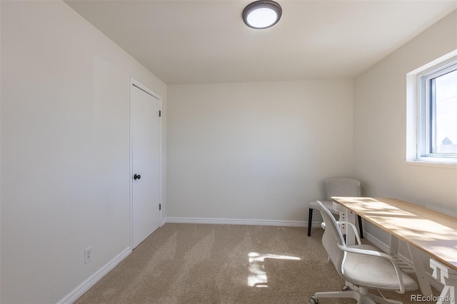 unfurnished office with baseboards and carpet floors