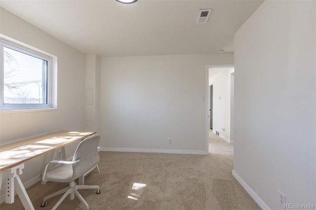 unfurnished office featuring visible vents, light colored carpet, and baseboards