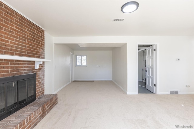 unfurnished living room featuring a fireplace, visible vents, carpet floors, and baseboards