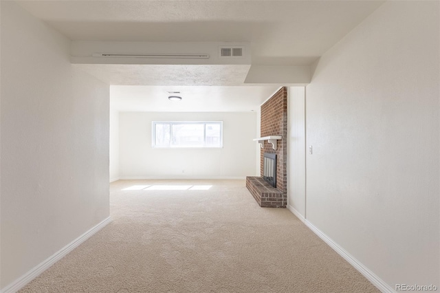 unfurnished living room featuring visible vents, baseboards, carpet flooring, and a fireplace