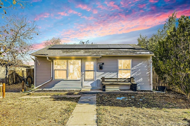 view of front of property with solar panels