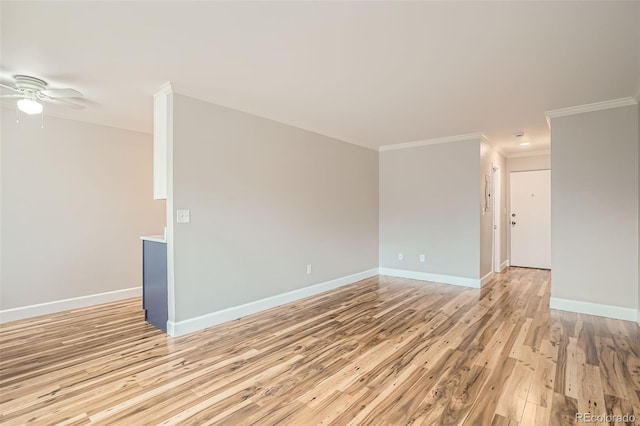 empty room featuring ornamental molding, light wood-type flooring, and ceiling fan