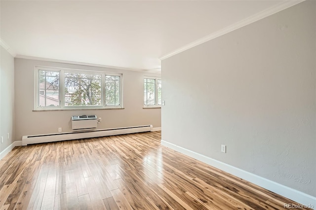 empty room with a healthy amount of sunlight, ornamental molding, light hardwood / wood-style flooring, and baseboard heating