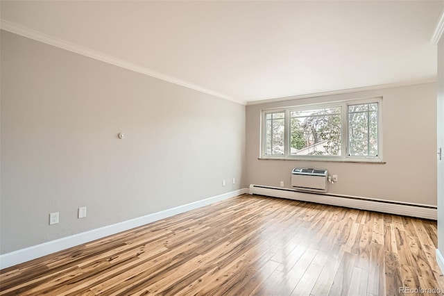 spare room featuring ornamental molding, light hardwood / wood-style flooring, a baseboard heating unit, and a wall mounted air conditioner