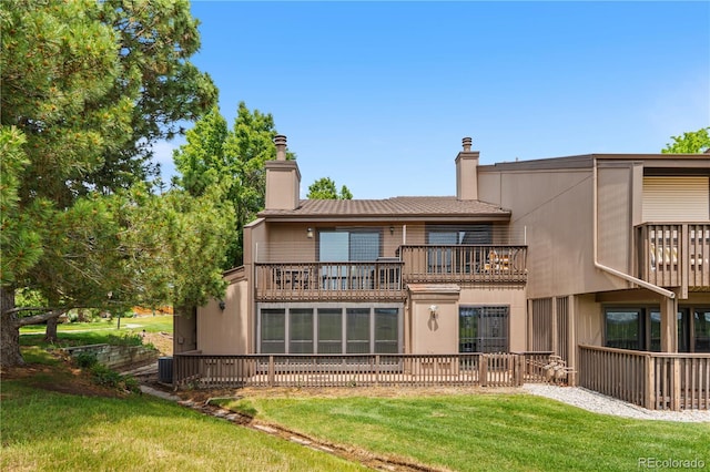 7300 W Stetson Pl Unit 46, Littleton, CO 80123 - back of house featuring a balcony, a chimney, a lawn, and central AC unit
